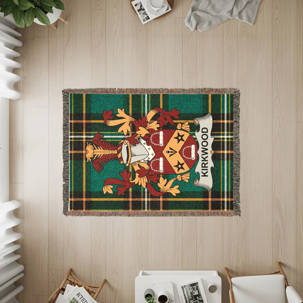 KIRKWOOD family crest woven throw blanket on a wooden floor.