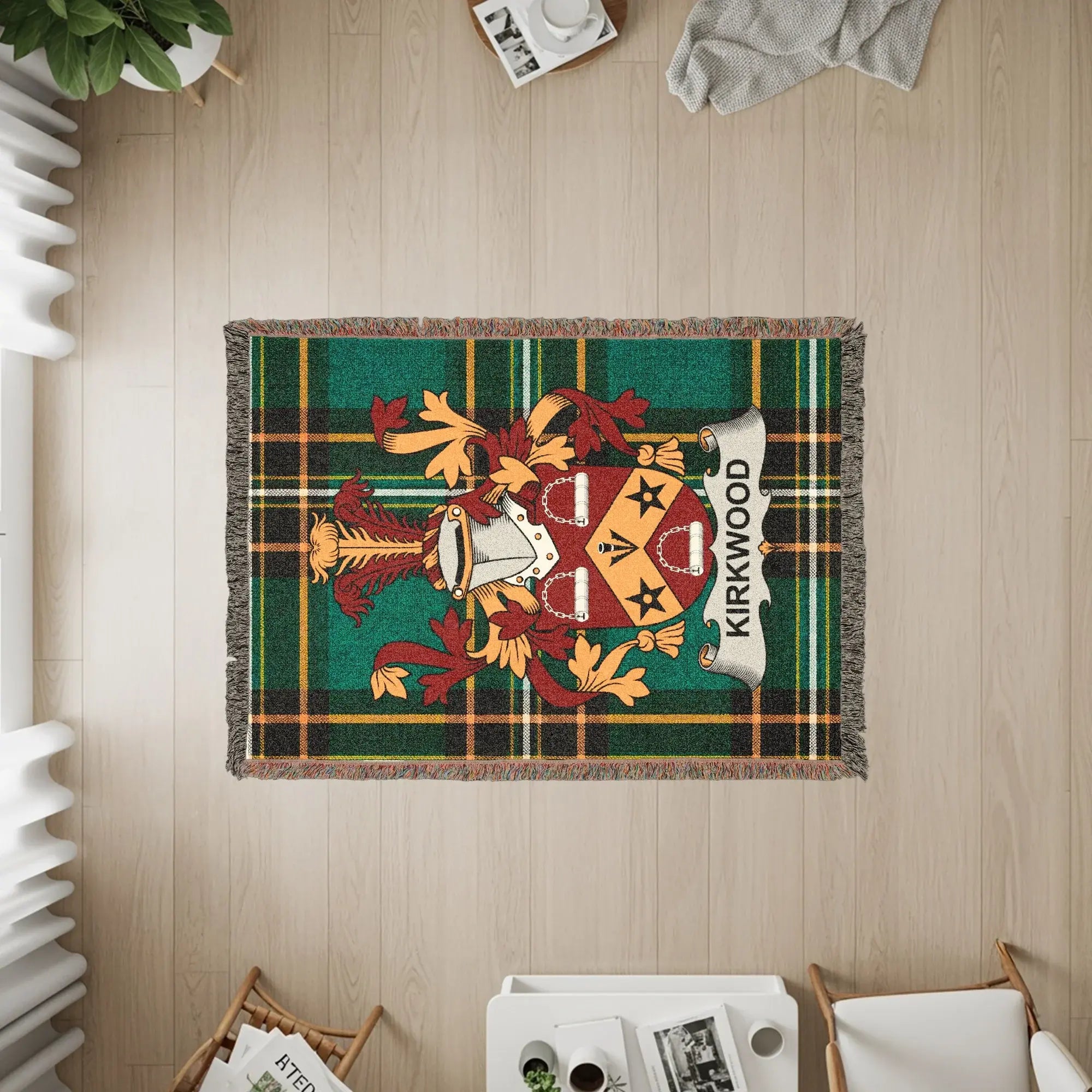 KIRKWOOD family crest woven throw blanket on a wooden floor.