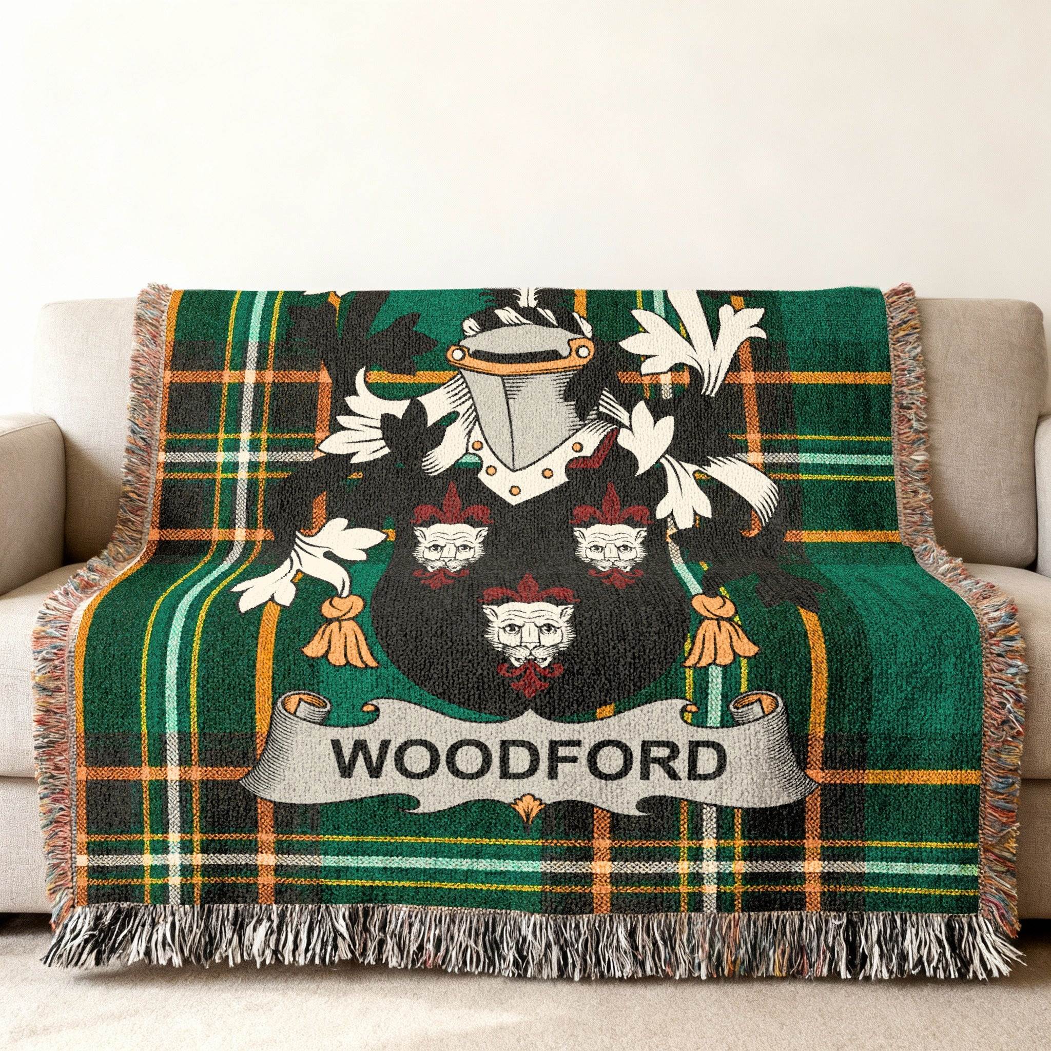 Woodford family crest on a green tartan throw blanket draped on a couch.