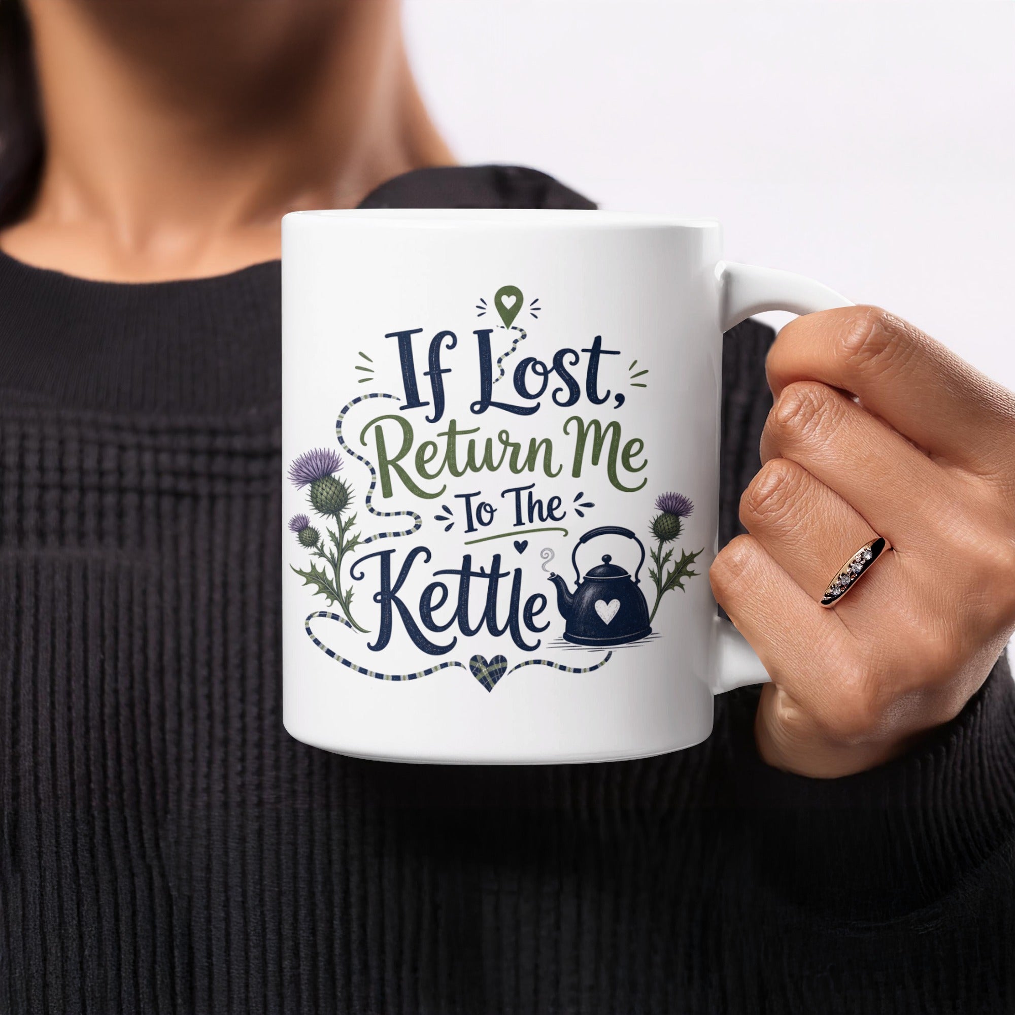 White mug with "If Lost, Return Me To The Kettle" text, thistle, and kettle illustration.