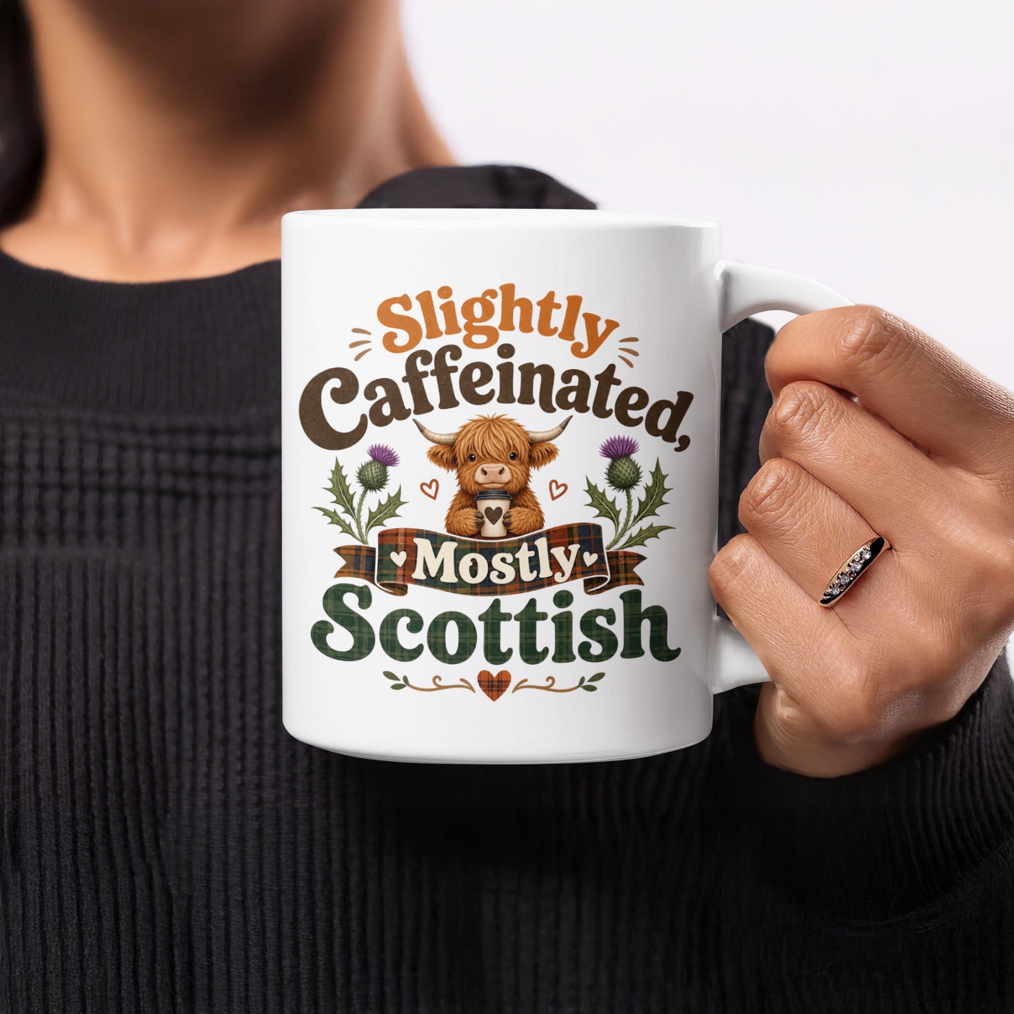 White mug with Highland cow and text "Slightly Caffeinated, Mostly Scottish".