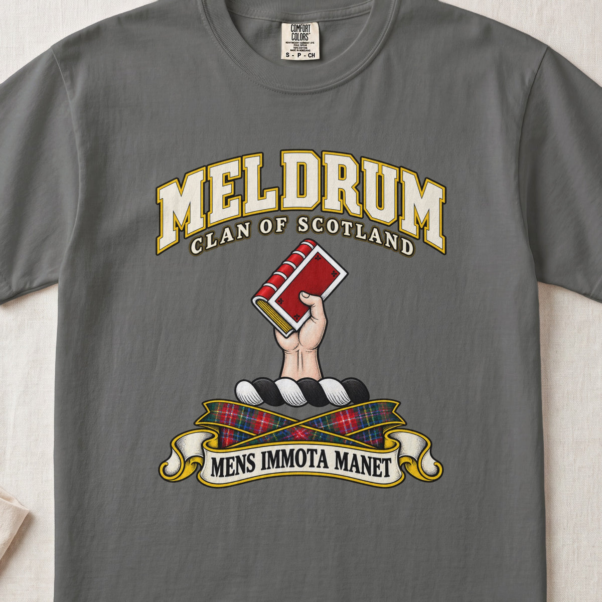 Meldrum Scottish clan T-shirt in Pepper, front view with a hand holding a red book and motto banner.