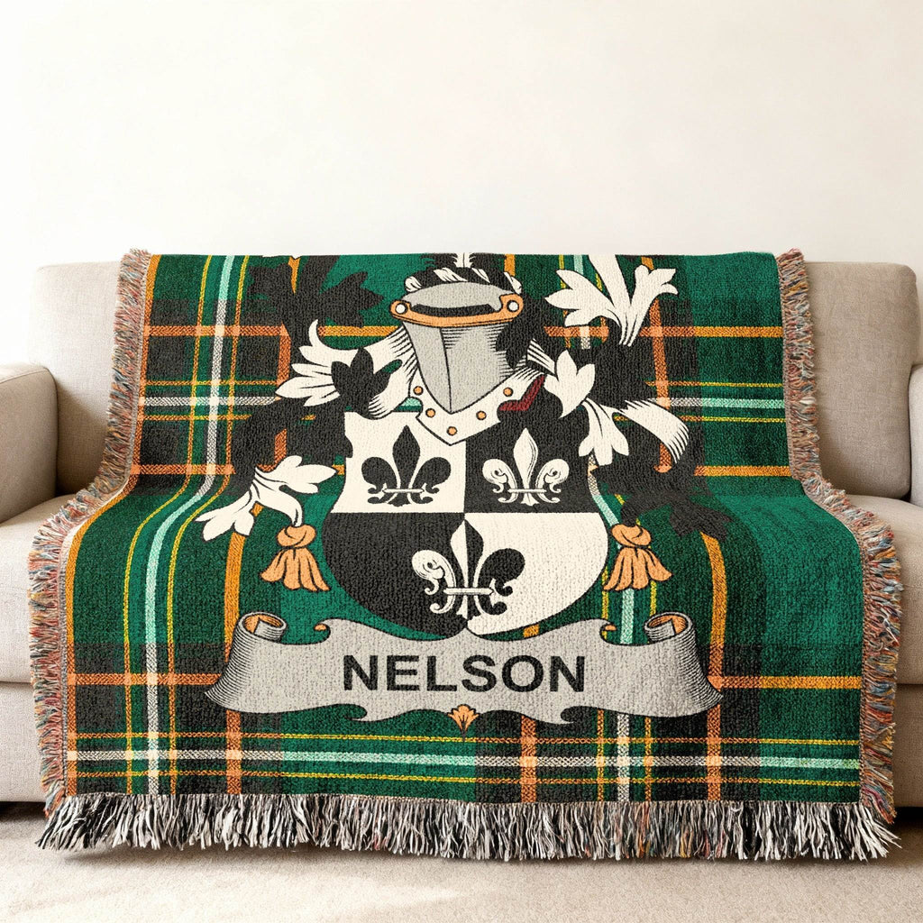 Nelson family crest on a green tartan throw blanket.