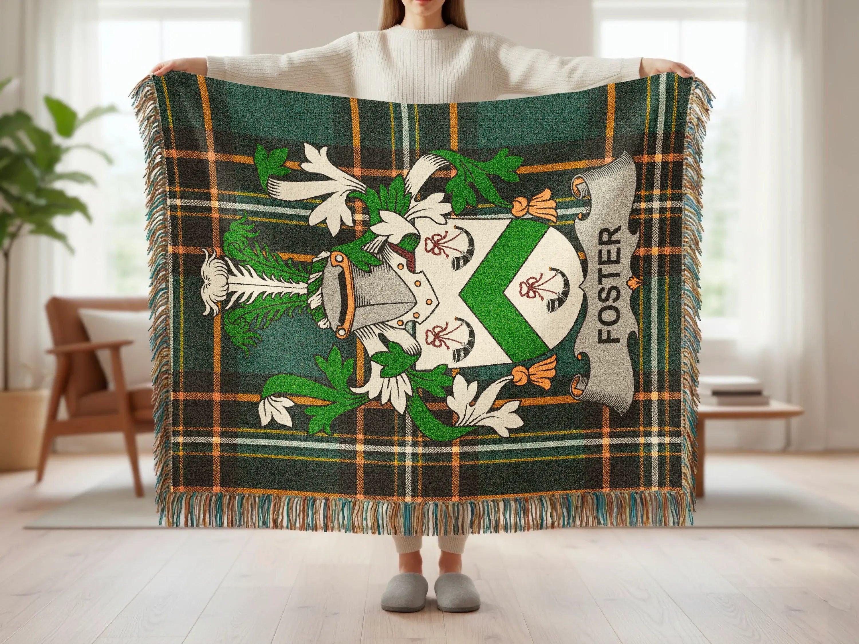 Foster tartan blanket with crest, held by a person.