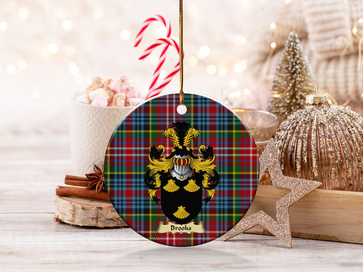 Brooks family emblem ceramic Christmas ornament with Caledonia tartan background in festive holiday décor