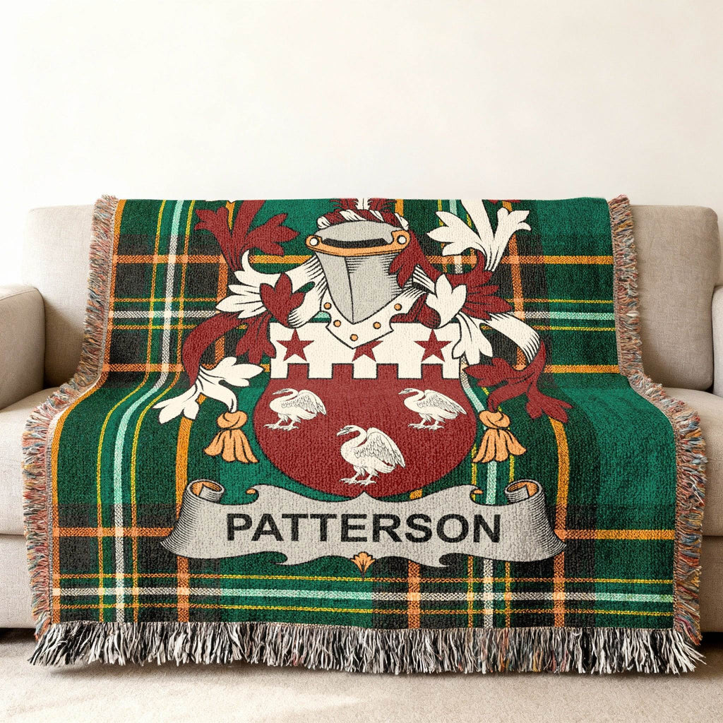 Woven throw blanket with green plaid and Patterson family crest.