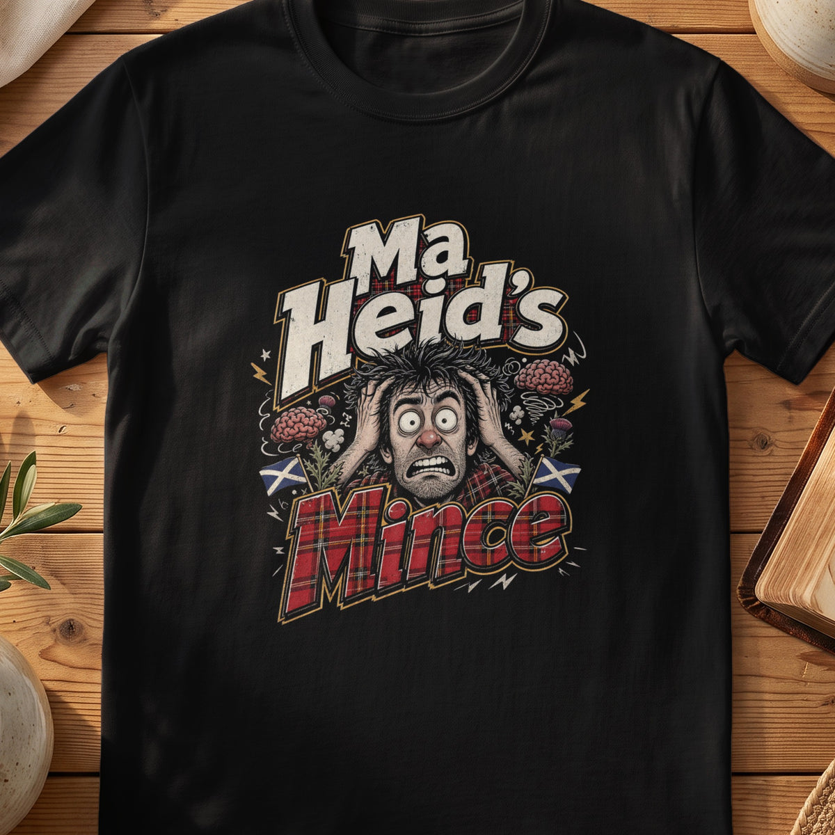 Black Gildan 64000 unisex T-shirt flatlay with Ma Heid's Mince Scottish graphic design