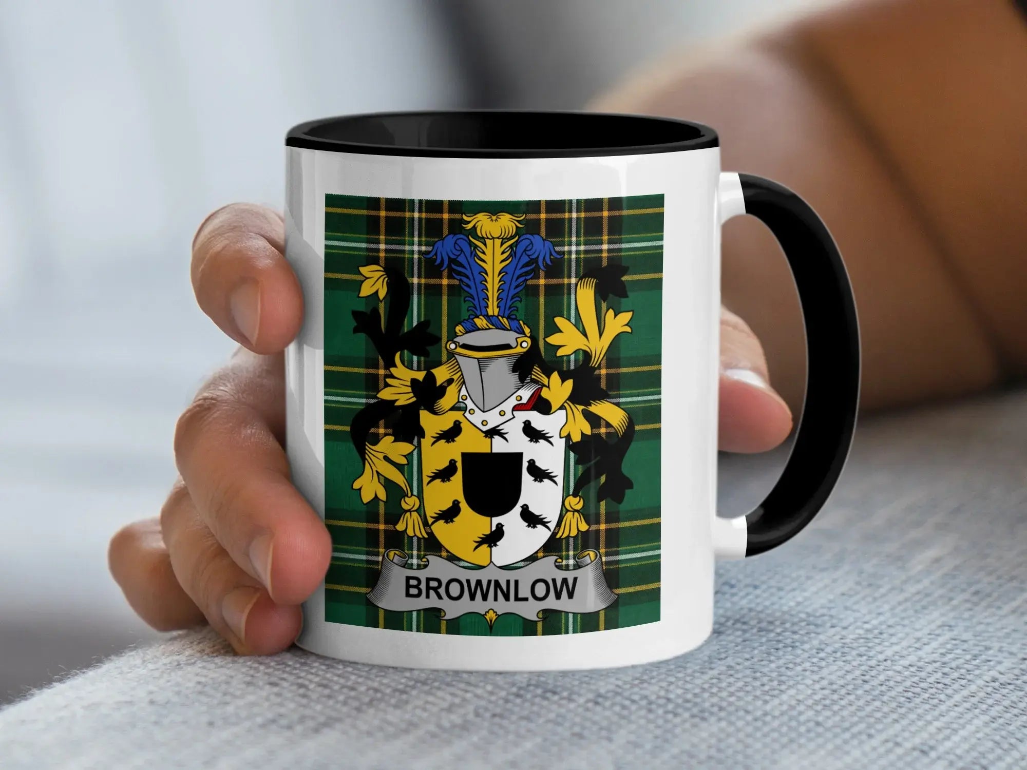 White mug with black handle, featuring a green tartan pattern and the Brownlow family crest.