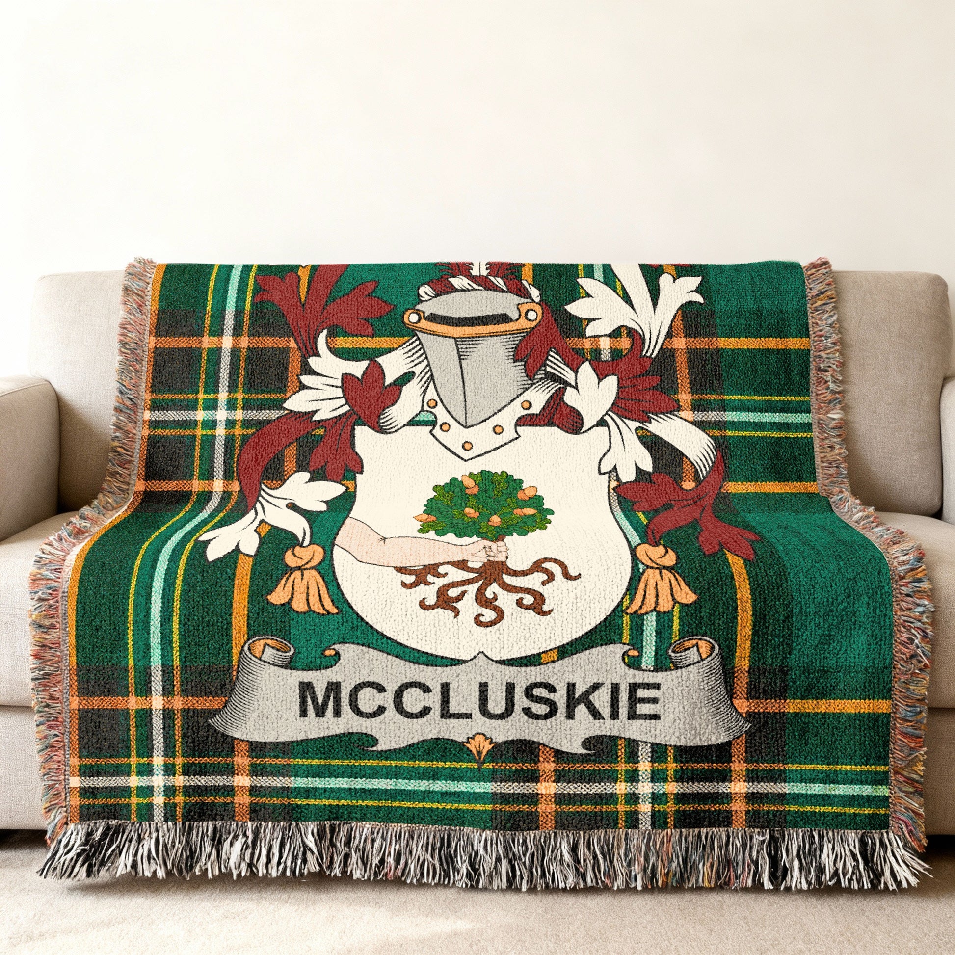 Tartan blanket with McCluskie family crest in center.