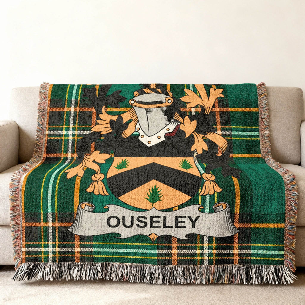 Green and black tartan throw blanket with OUSELEY crest displayed.
