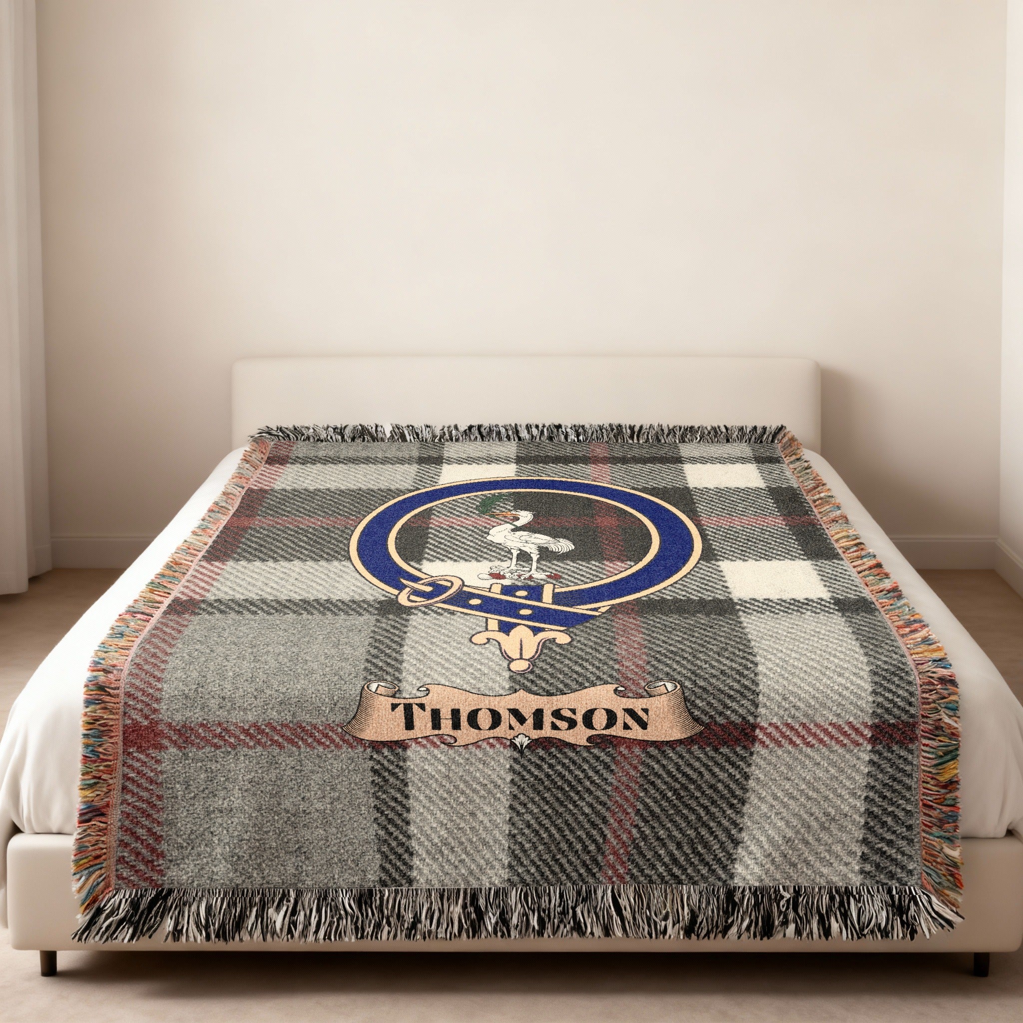 Thomson family crest and name on grey tartan woven blanket