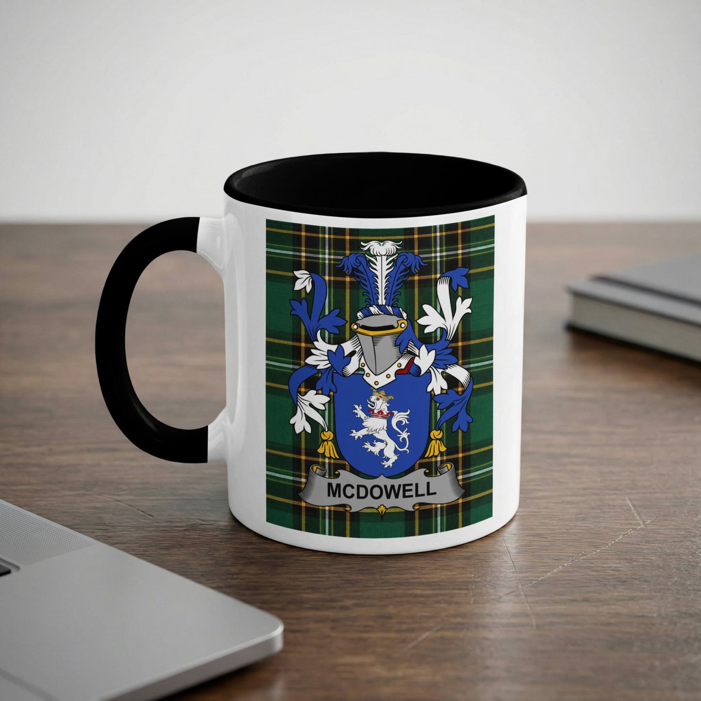 White mug with black handle displaying the McDowell family crest on a tartan background.