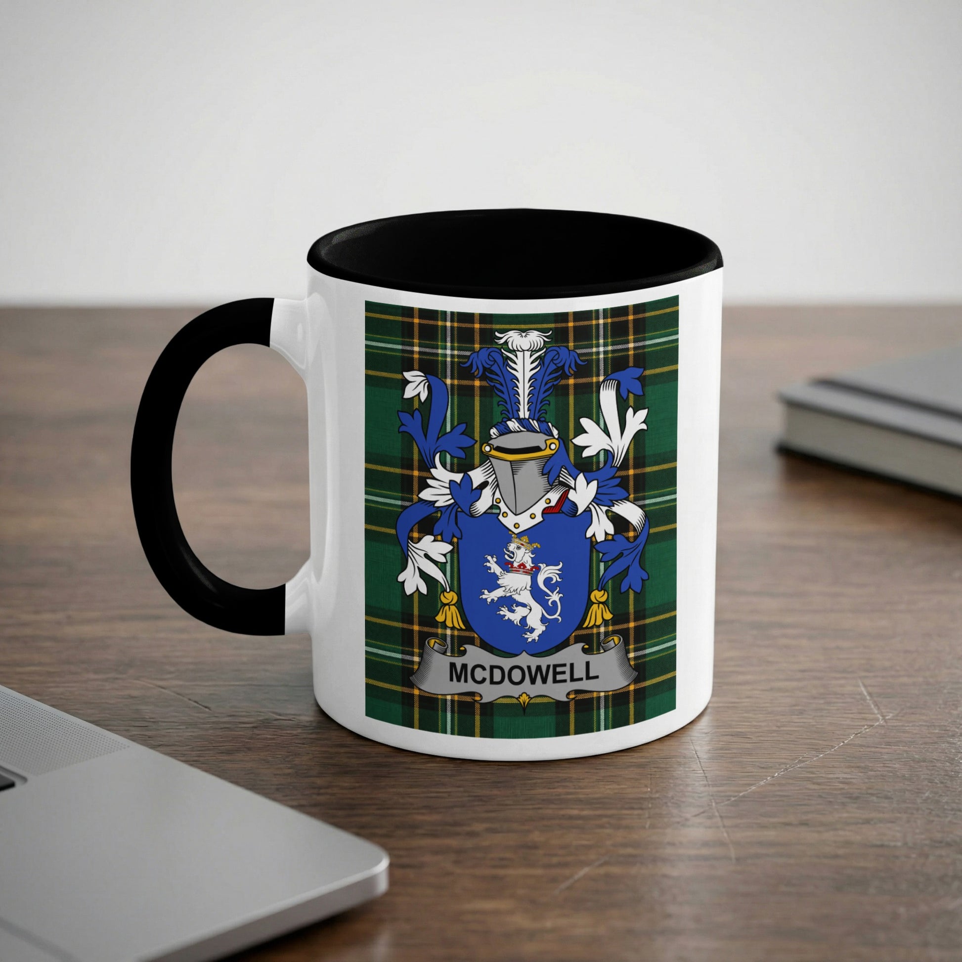 White mug with black handle displaying the McDowell family crest on a tartan background.