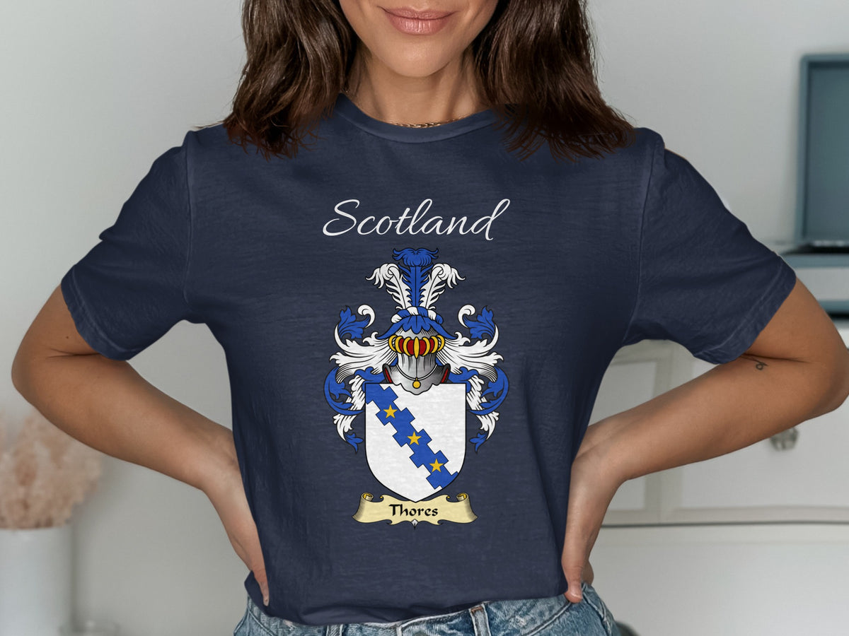 Model wearing the navy Thores family crest T-shirt featuring “Scotland” and the surname banner.