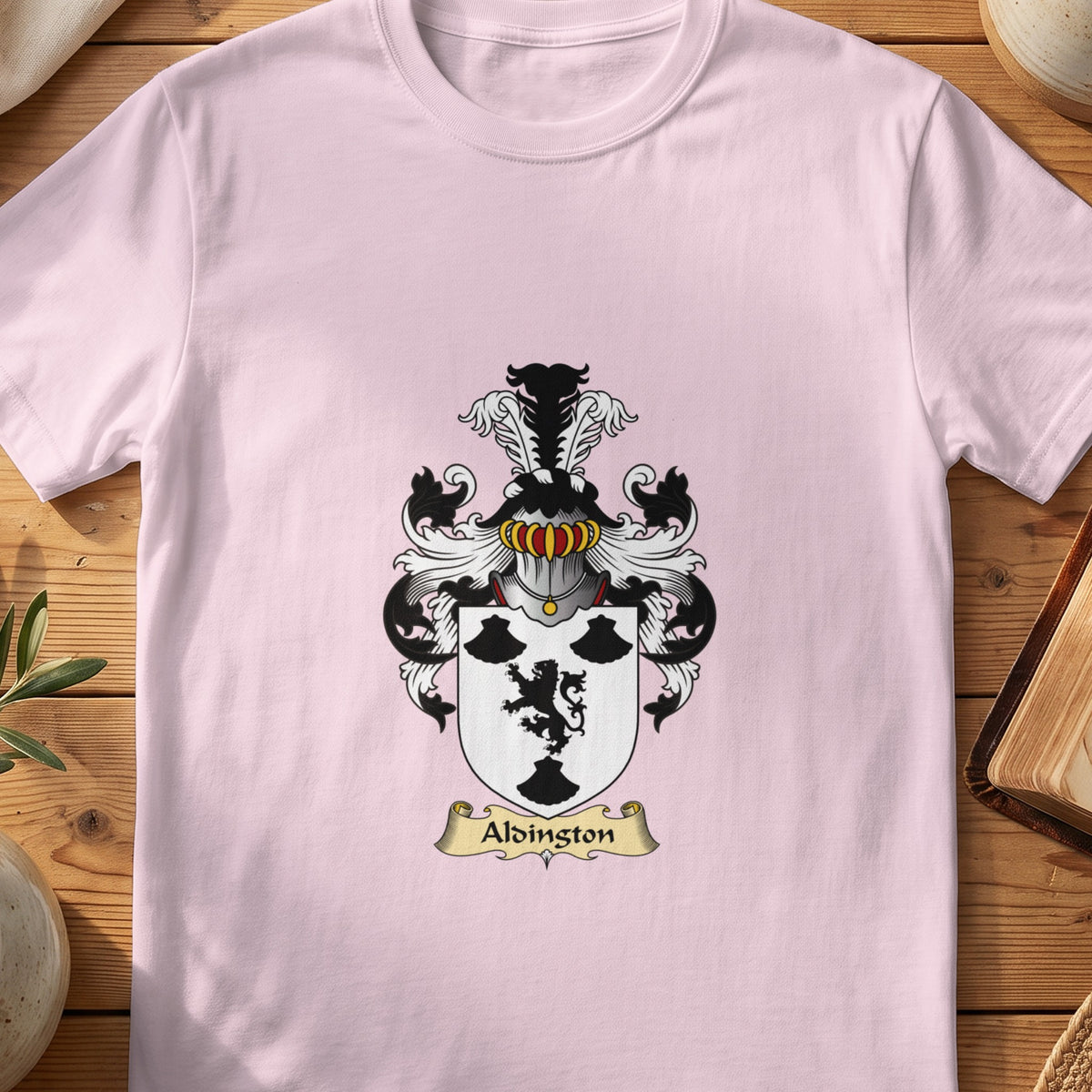 Light Pink Aldington Scottish family shield T-shirt featuring a black lion and black motifs on white
