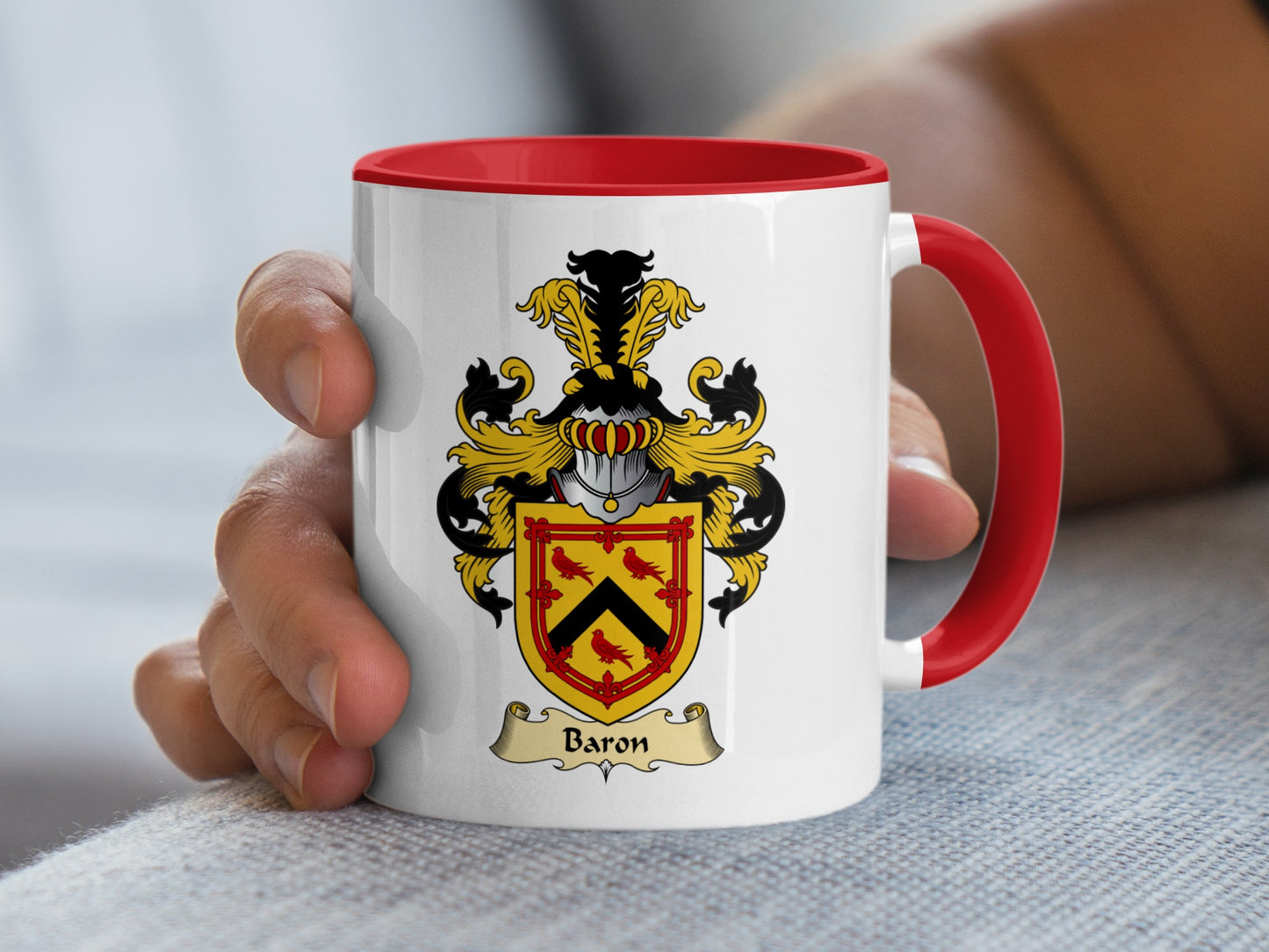 White mug with red handle, featuring a family crest with the name "Baron".