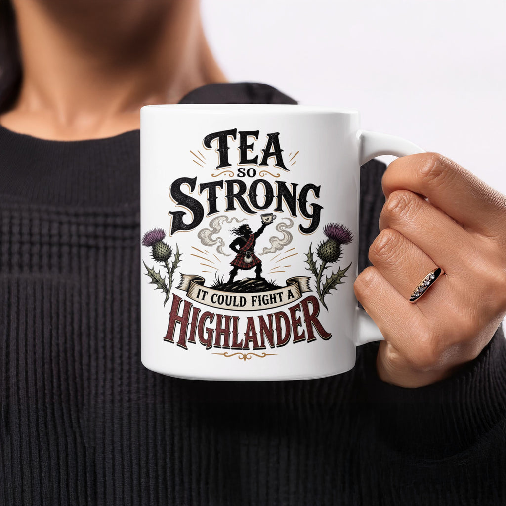 Mug with text "Tea so strong it could fight a Highlander" and thistle graphics.