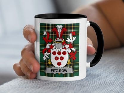 White mug with black rim displaying Fitz-Row family crest on tartan background.