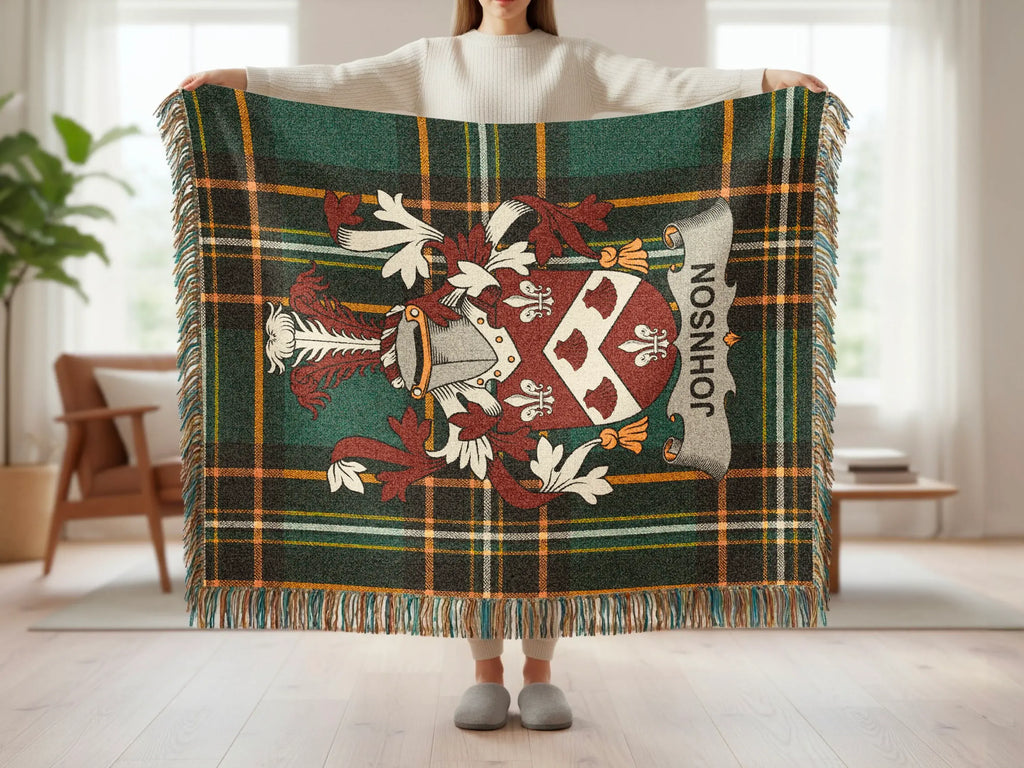 Tartan blanket with family crest and "JOHNSON" banner held by a person.