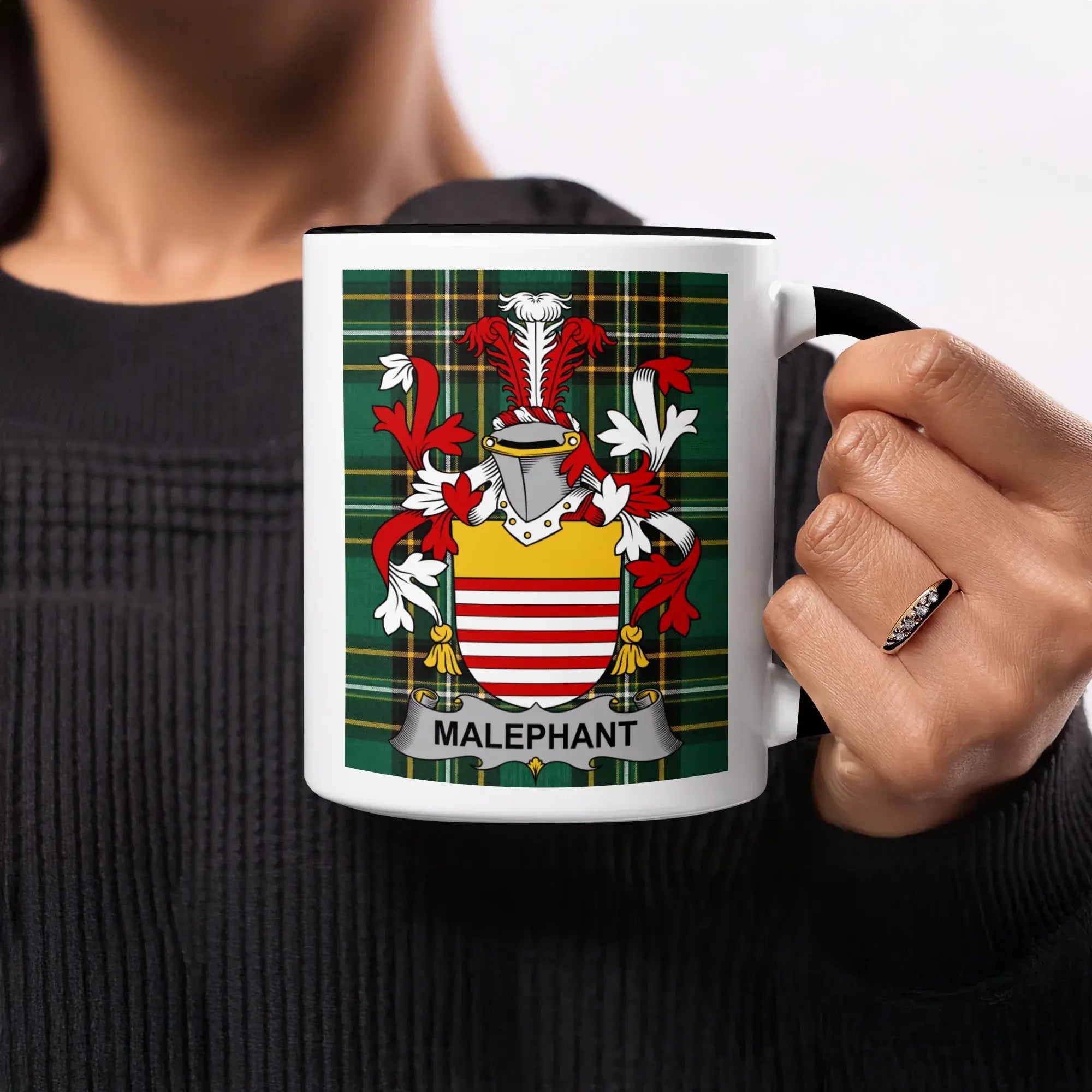 White mug with Malaphan family crest on green tartan background.