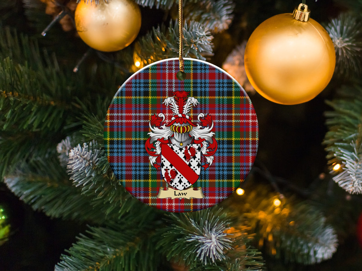 Law family emblem ceramic Christmas ornament with Caledonia tartan background in festive holiday décor