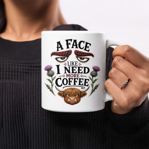 White mug with "A face like I need more coffee" and a grumpy bull design.