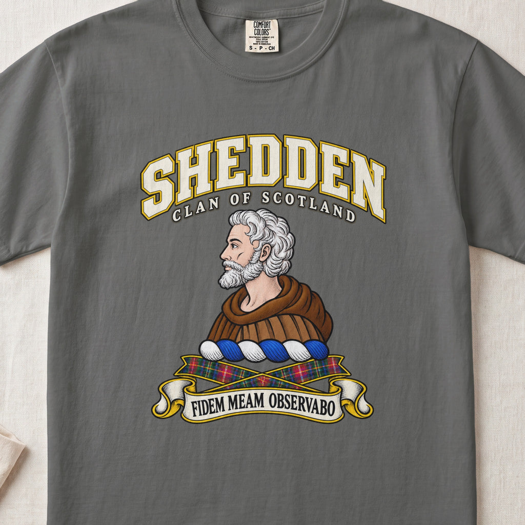 Shedden Scottish clan T-shirt in Pepper, front view with a gray-haired, bearded figure in a brown robe and motto design.