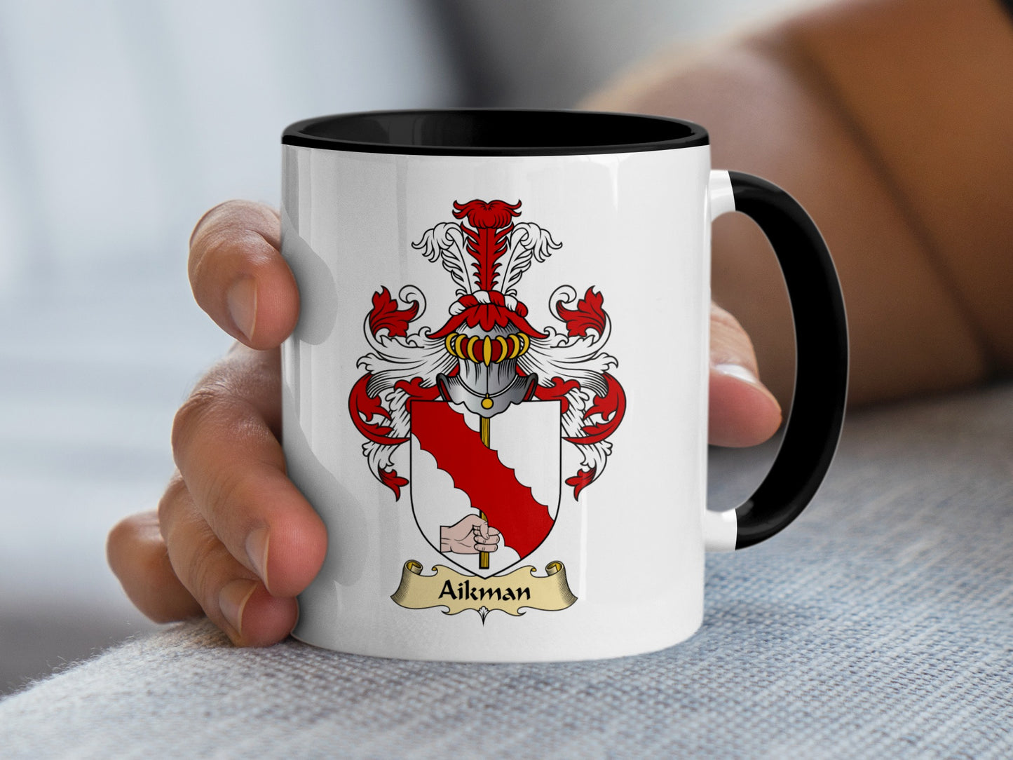 White mug with black handle featuring Aikman coat of arms and surname.