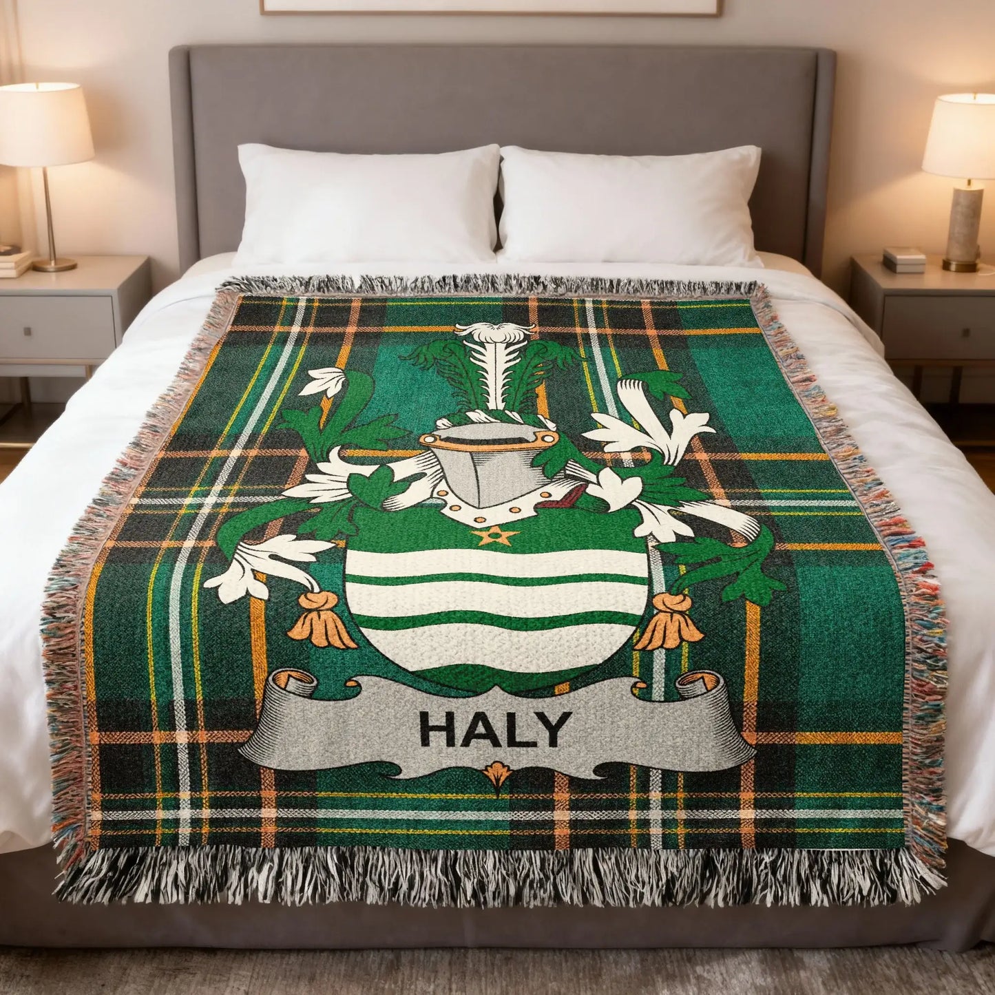 Green tartan blanket with HALY crest displayed on a bed.