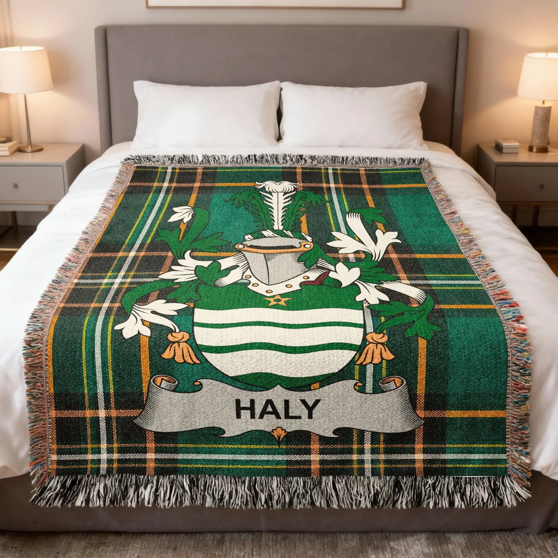 Green tartan blanket with HALY crest displayed on a bed.