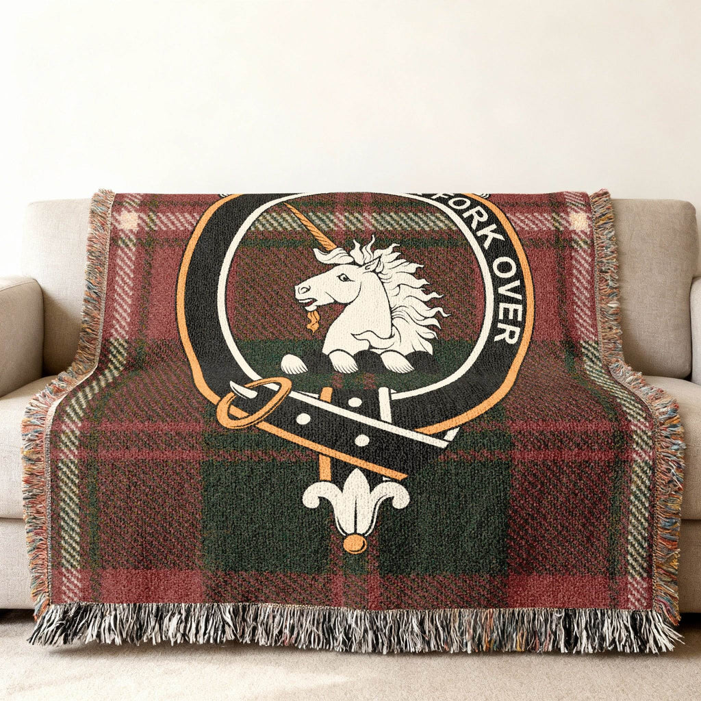 Cunningham tartan woven blanket draped — heraldic unicorn plaid crest, fringe edges