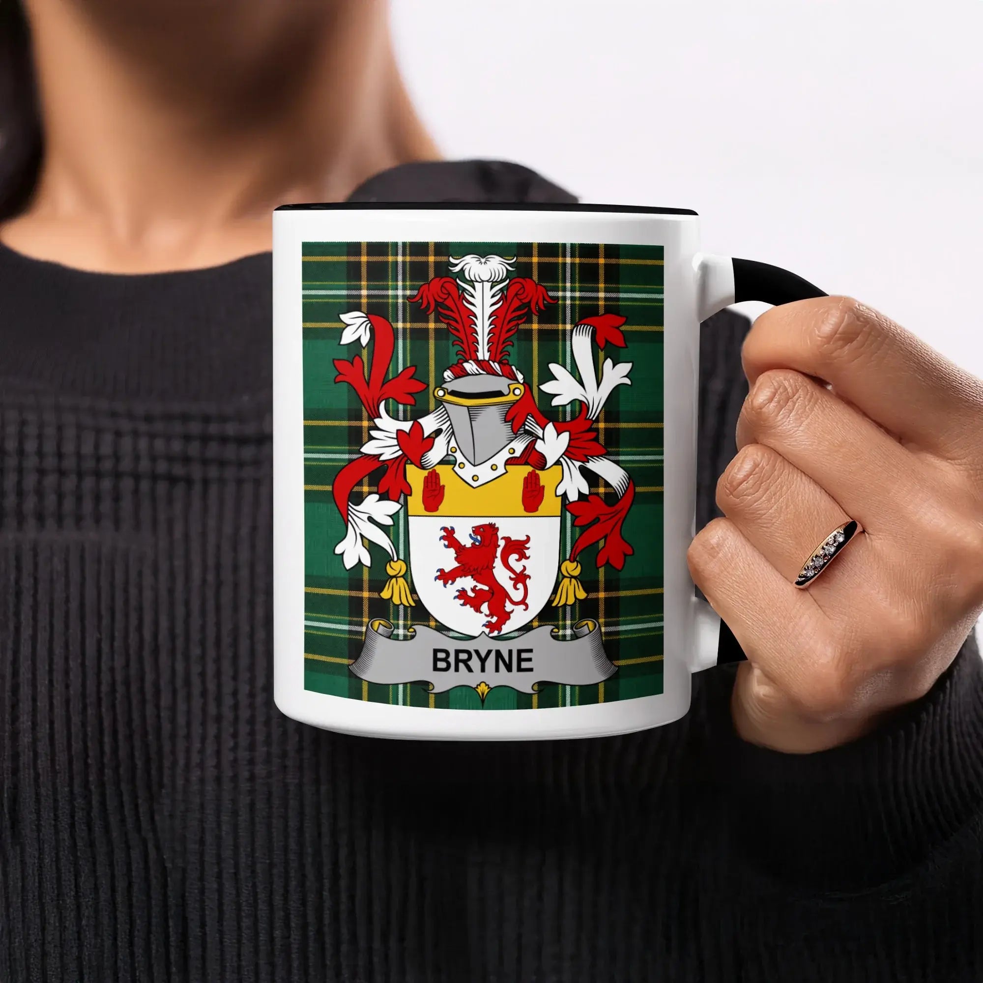 White mug with green plaid and coat of arms bearing the name BRYNE.