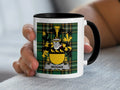 Mug with a Wogan family crest on a green tartan background.