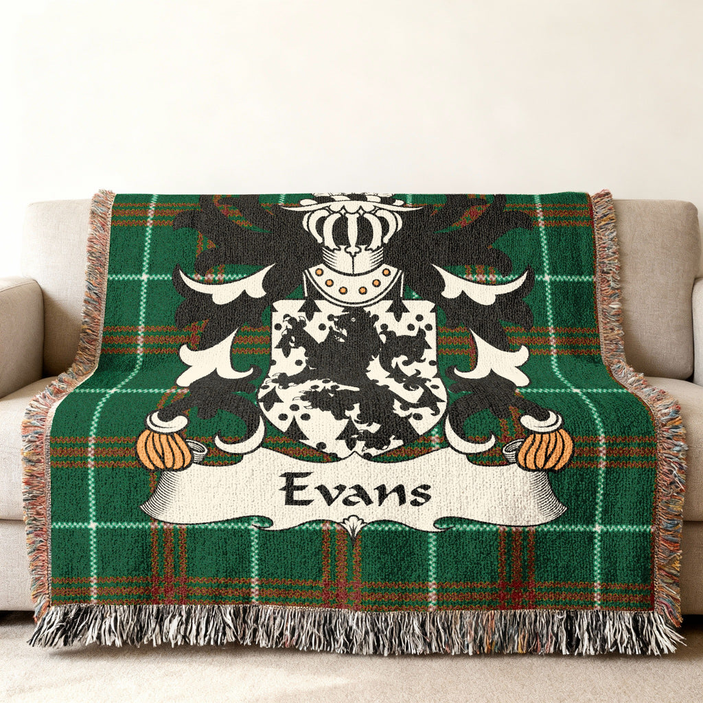 Green tartan blanket with a coat of arms and the name "Evans".