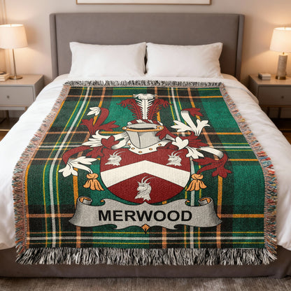 Merwood family crest on a green plaid throw blanket on a bed.
