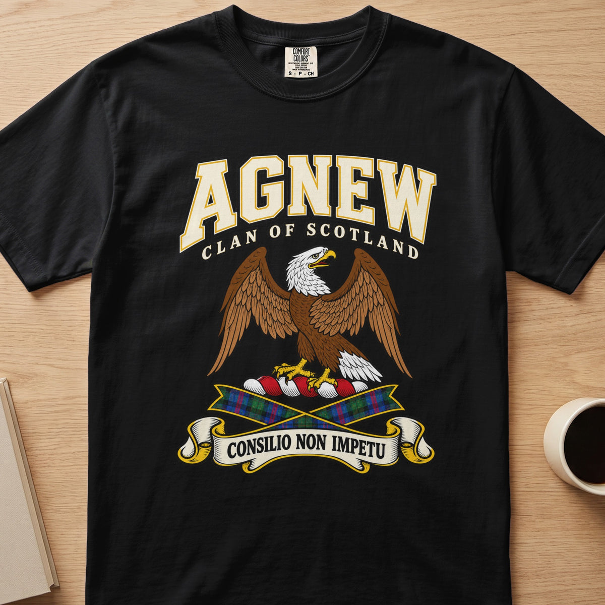 Agnew brown spread-wing bird crest graphic on a black Comfort Colors T-shirt, front view