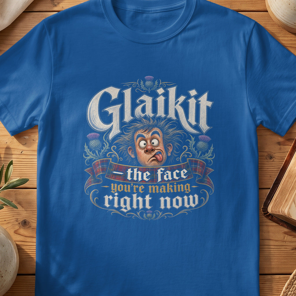 Blue t-shirt with "Glaikit - the face you're making right now" text and cartoon face.