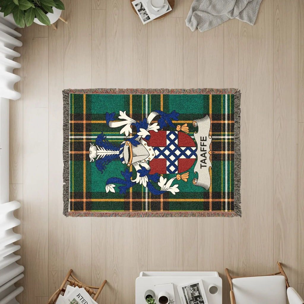 Taafe family crest woven tapestry rug on wooden floor with furniture.
