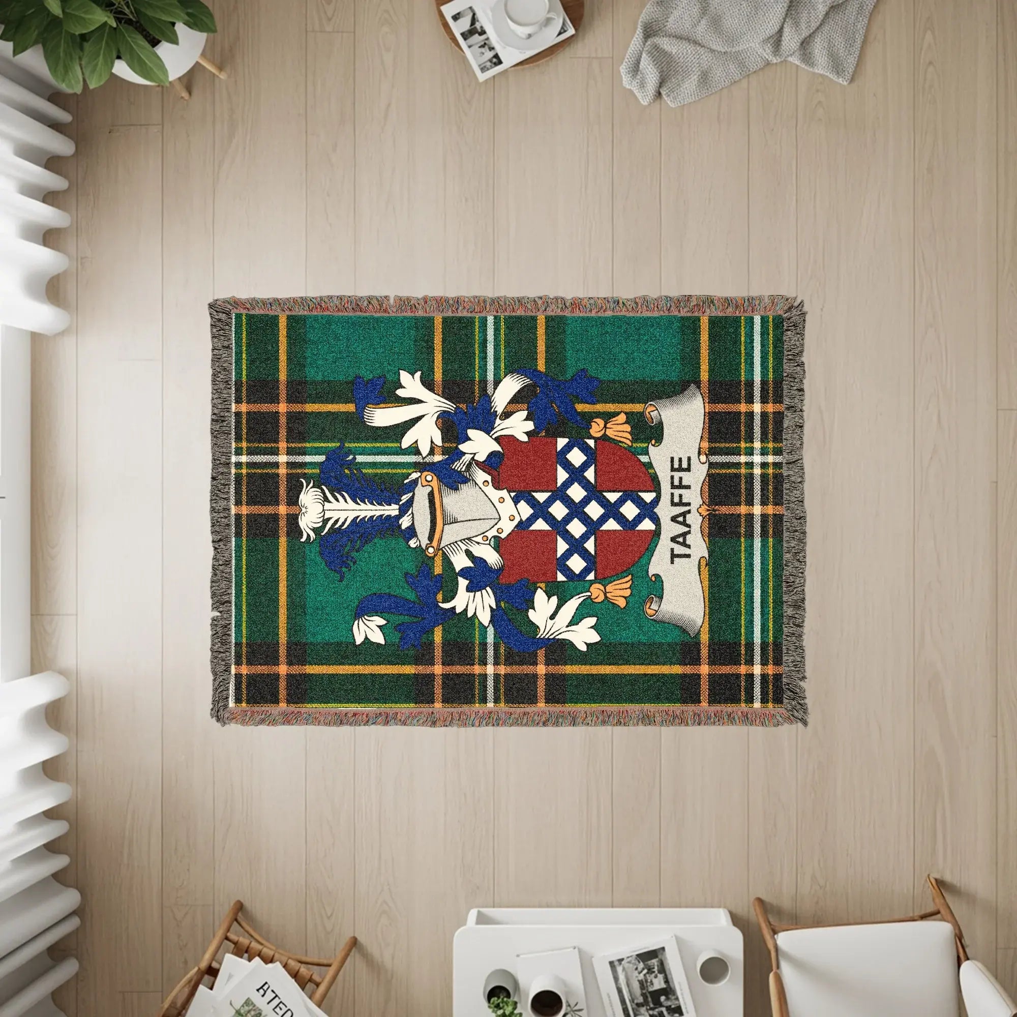 Taafe family crest woven tapestry rug on wooden floor with furniture.