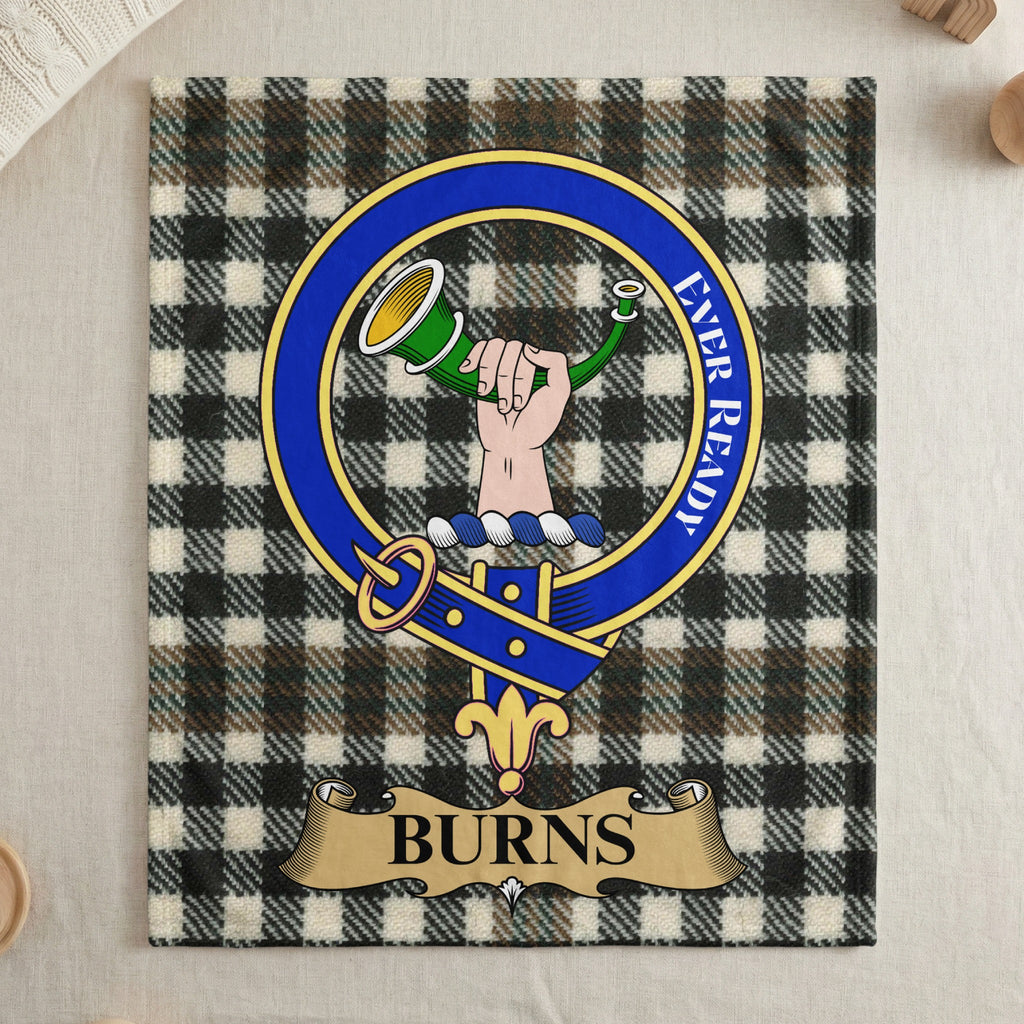 Burns clan crest on tartan throw blanket — draped display