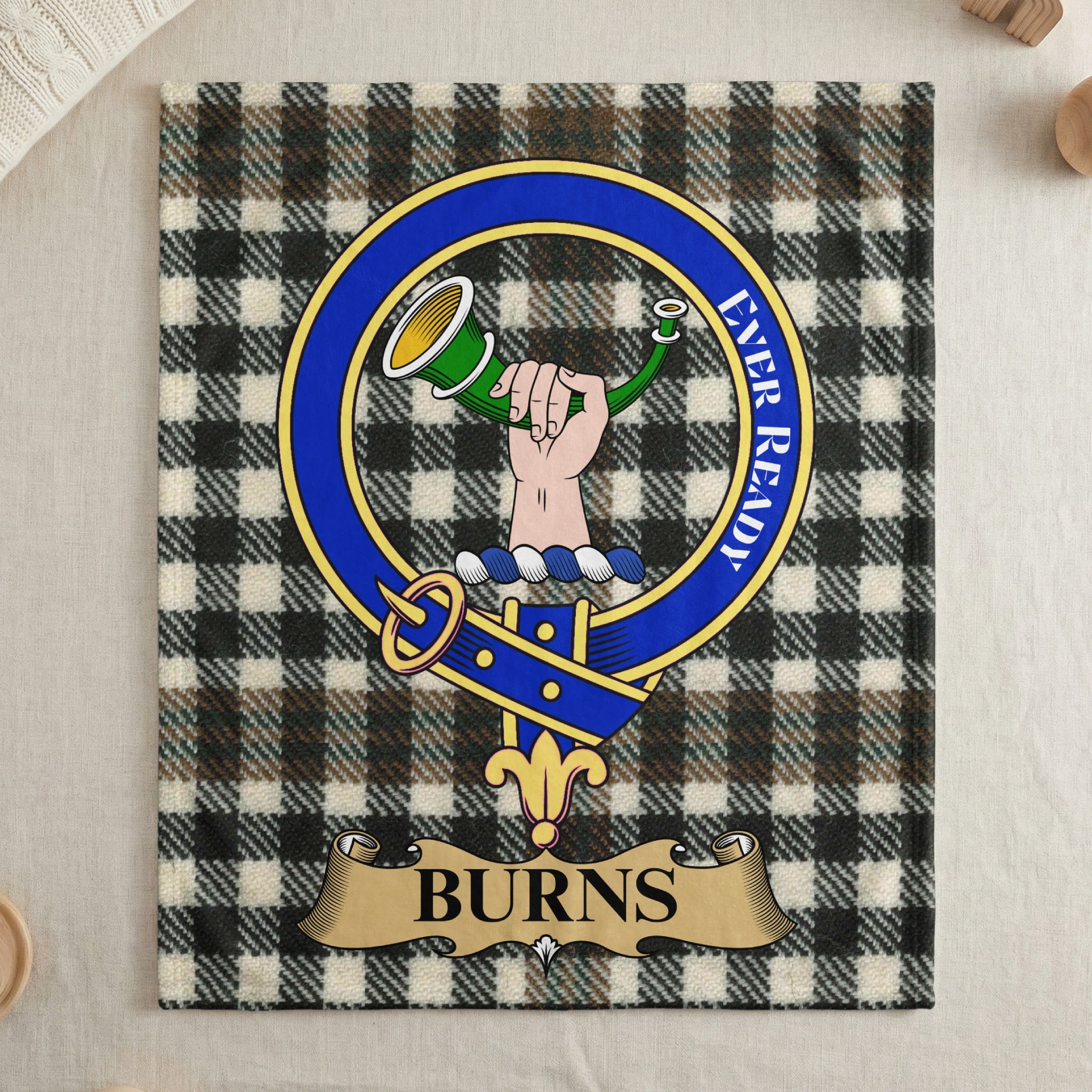 Burns clan crest on tartan throw blanket — draped display