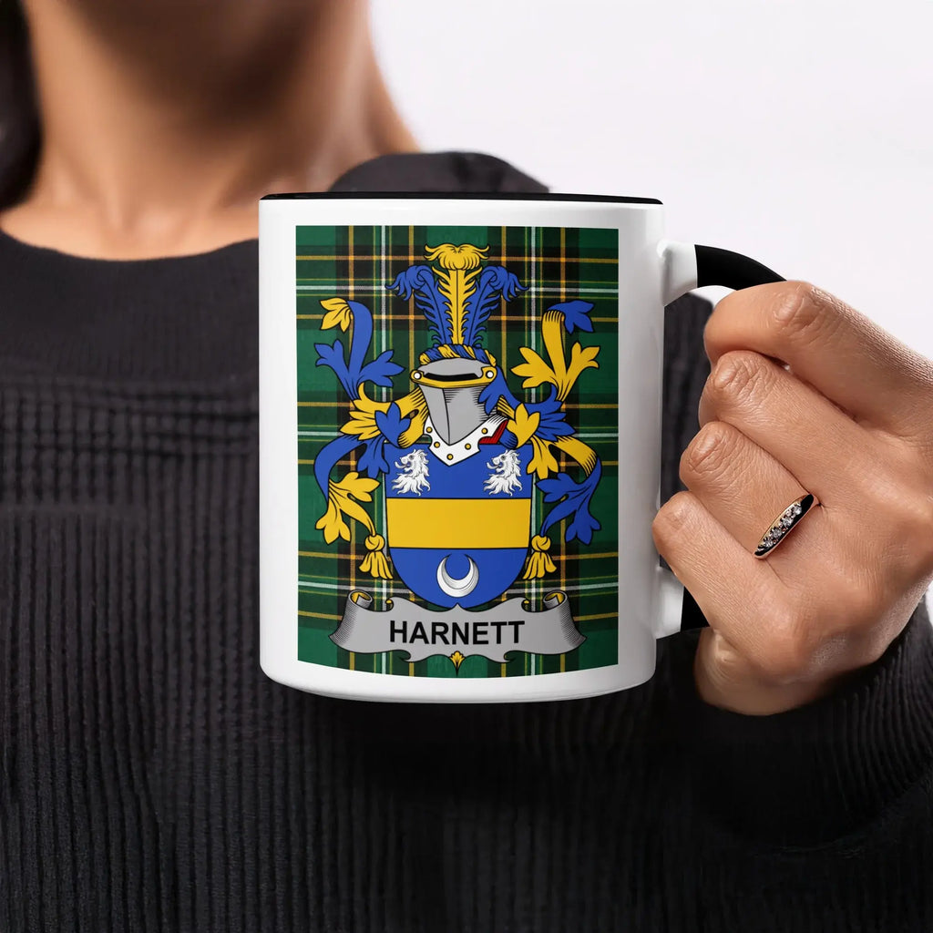 Black mug with white interior featuring the Harnett family crest on a tartan pattern.
