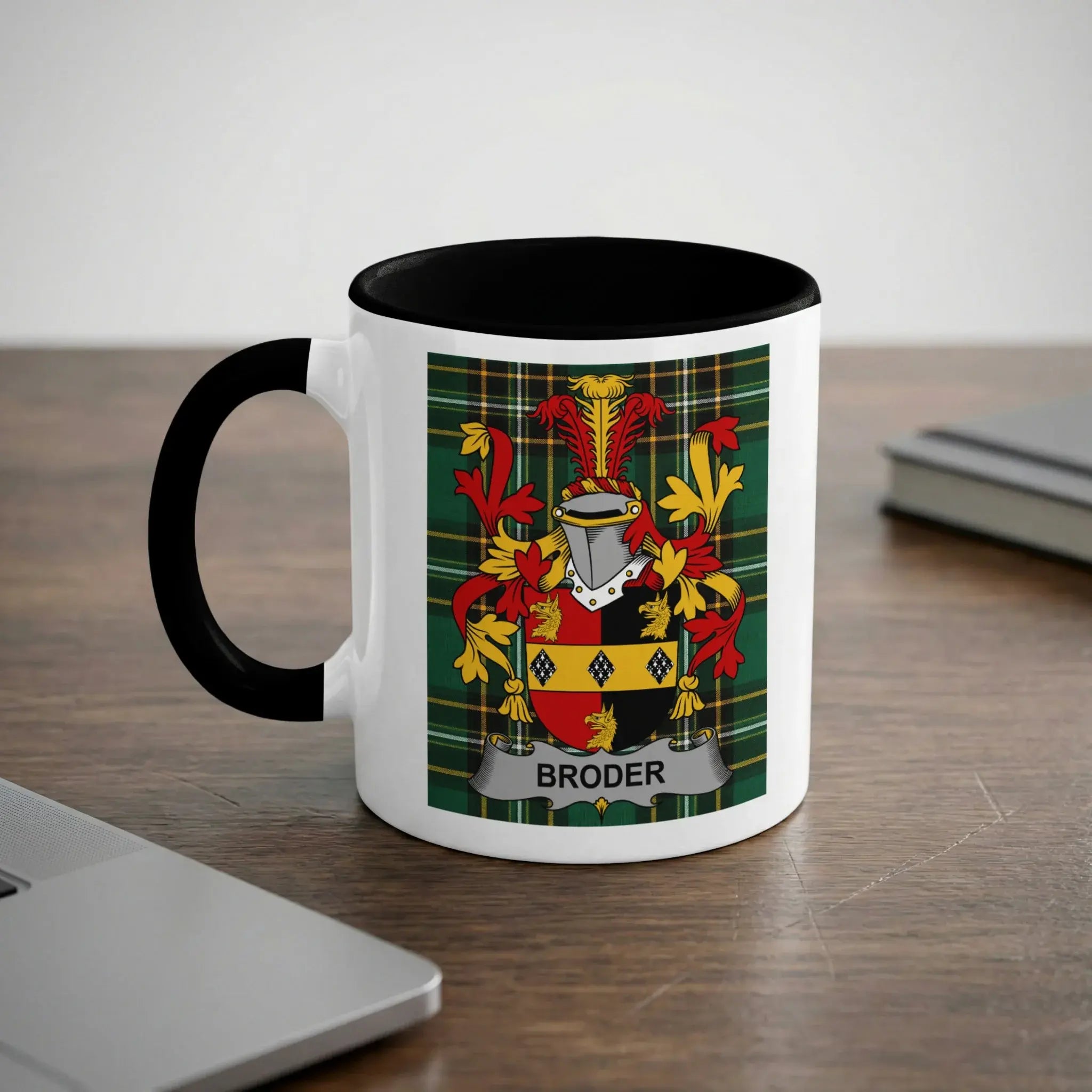 White mug with black handle, featuring a coat of arms with the text "BRODER".