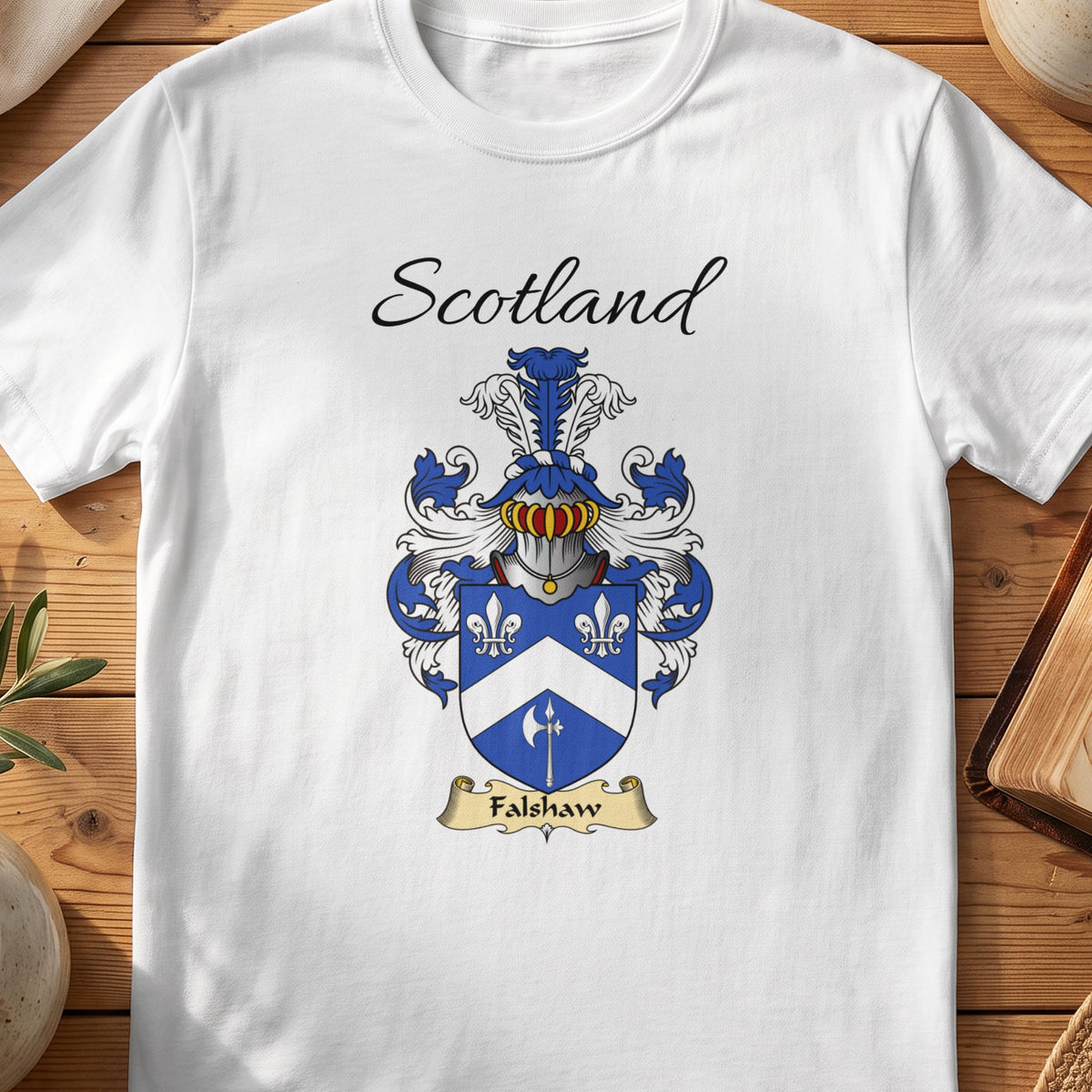 White Falshaw Scottish family shield T-shirt featuring a white chevron and floral motifs on blue