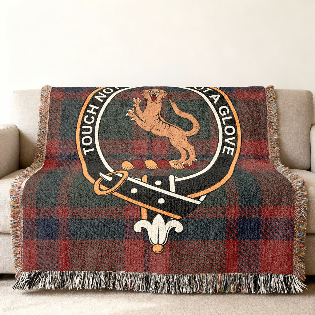 Mackintosh clan crest with wildcat and motto on tartan woven blanket