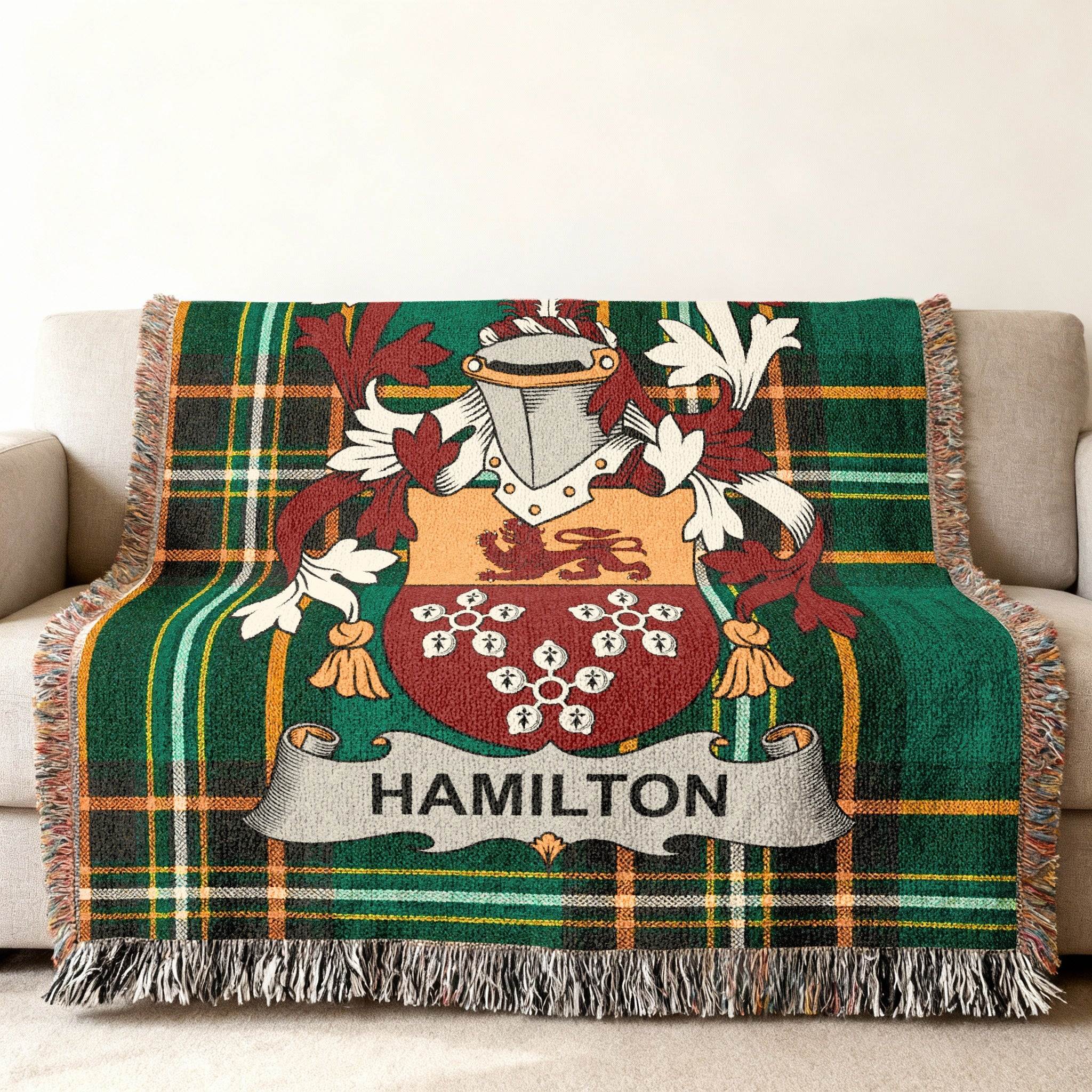 Hamilton family crest on a green and red plaid woven blanket.