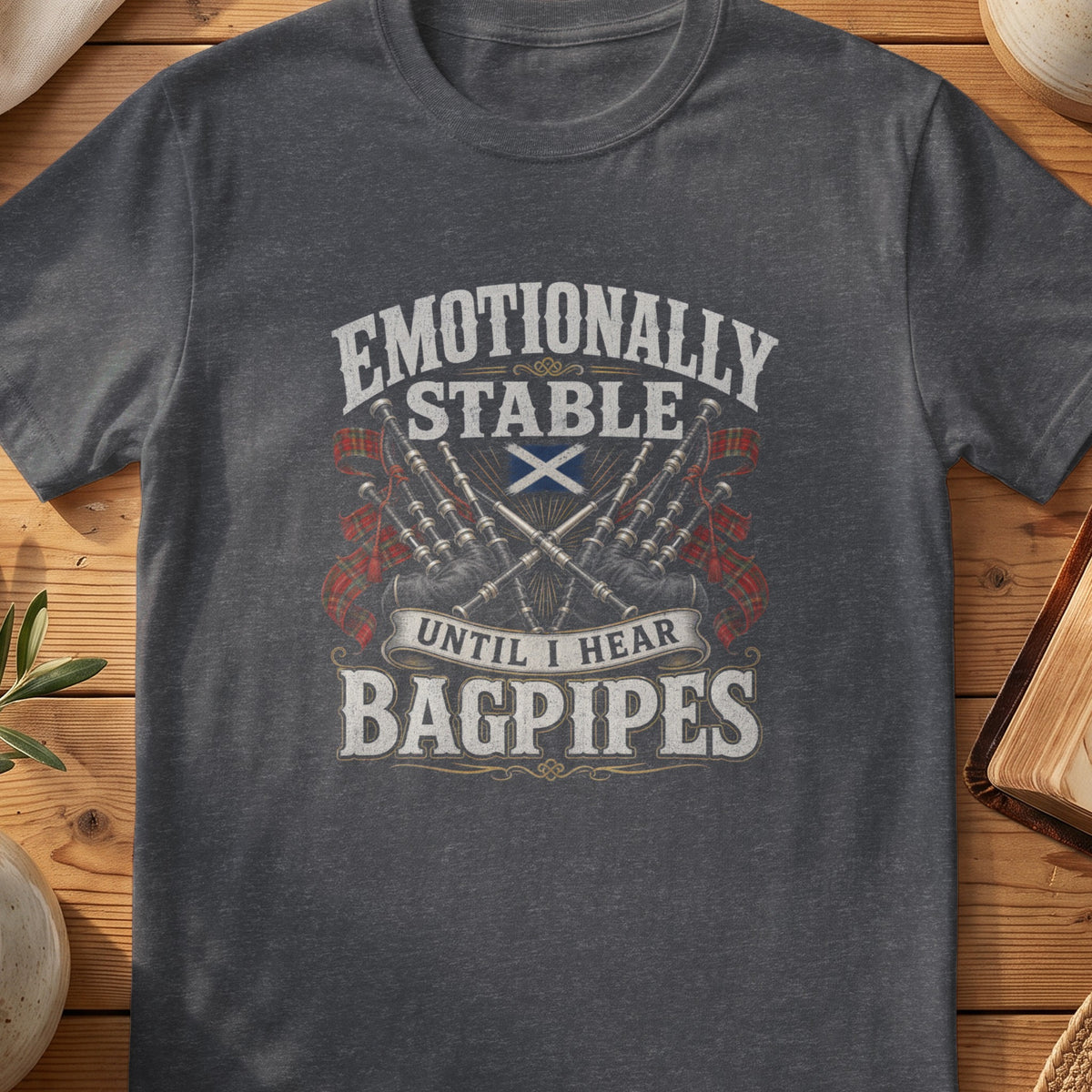 Dark grey Gildan 64000 unisex T-shirt flatlay with Emotionally Stable Until I Hear Bagpipes Scottish graphic design