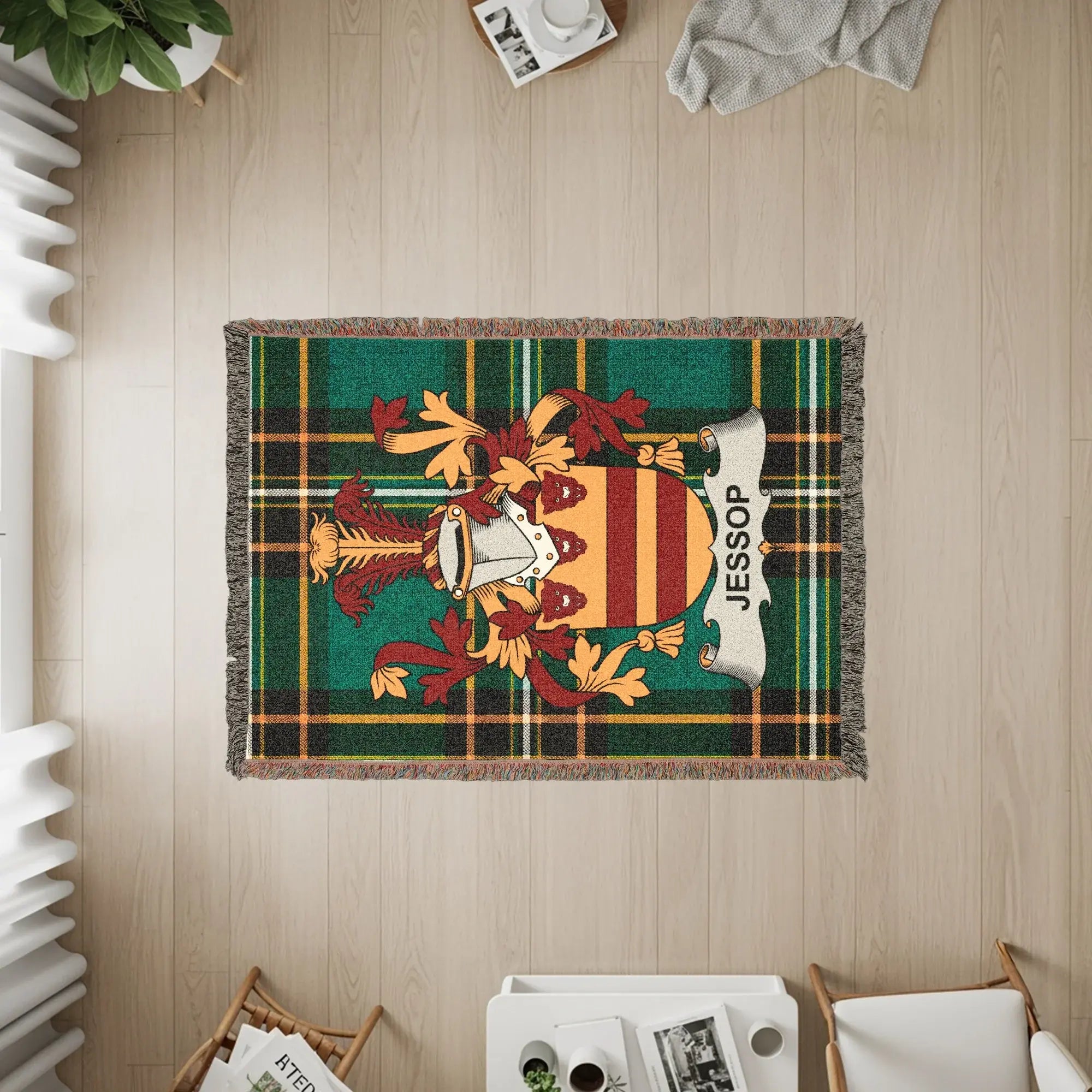 Tapestry blanket with Jessop family crest on green plaid background.