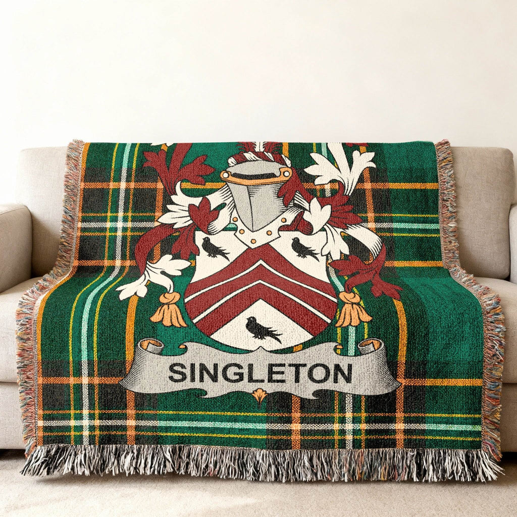 Tartan blanket with Singleton family crest in green, white, and red.