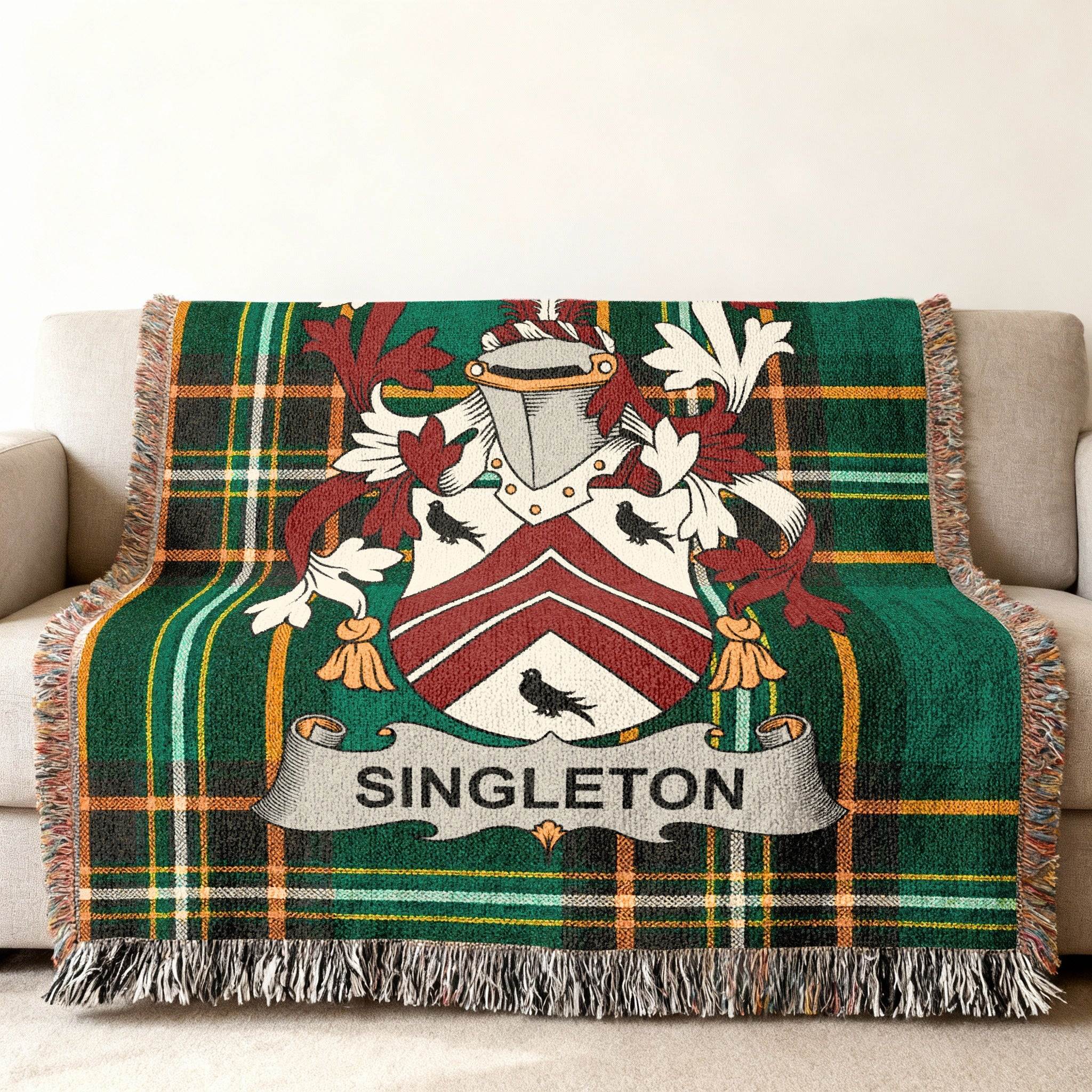 Tartan blanket with Singleton family crest in green, white, and red.